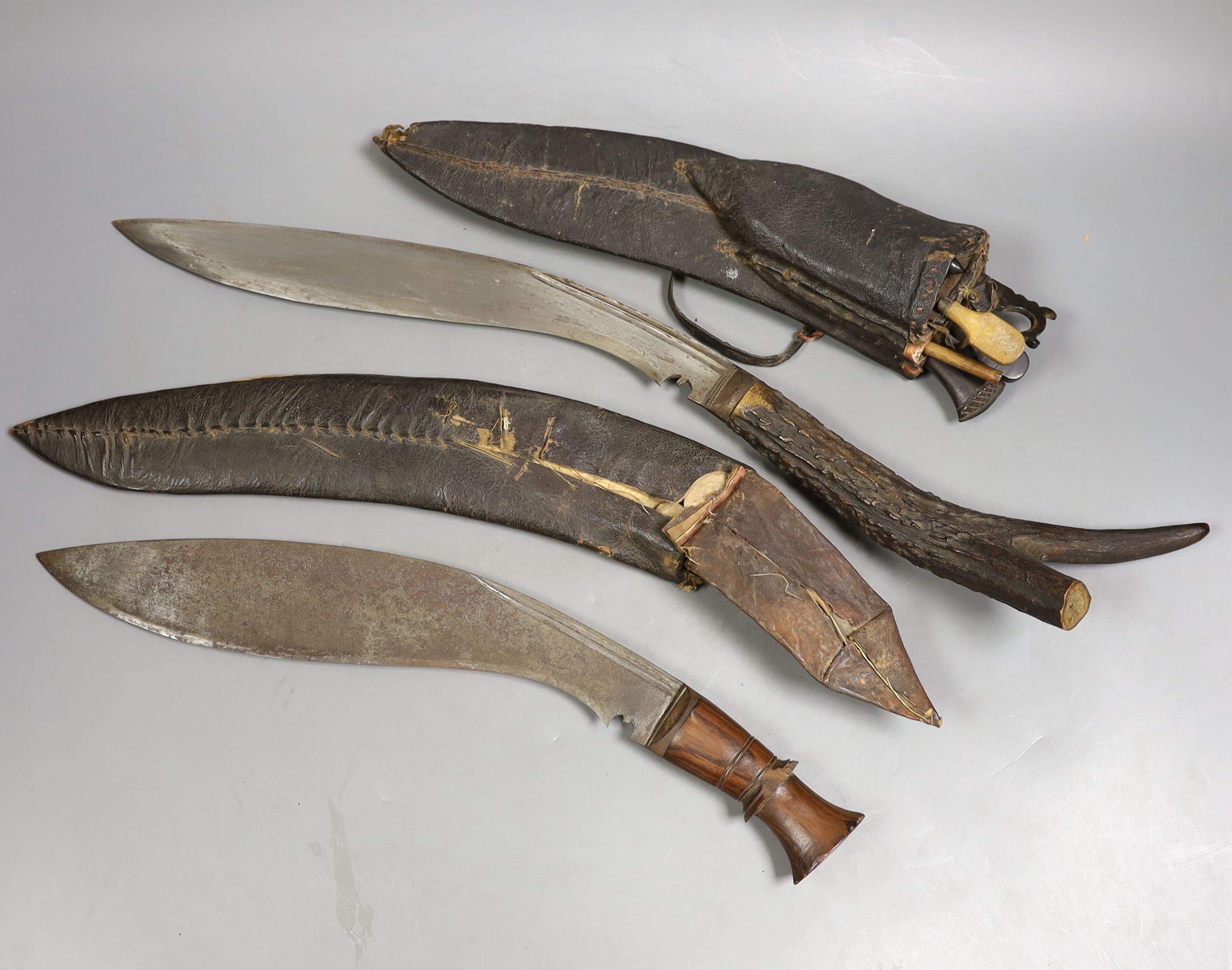 Two Nepalese kukri knives, antler handle knife 55cms long.